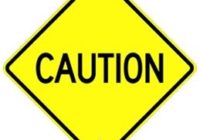 Yellow caution sign with bold black text.